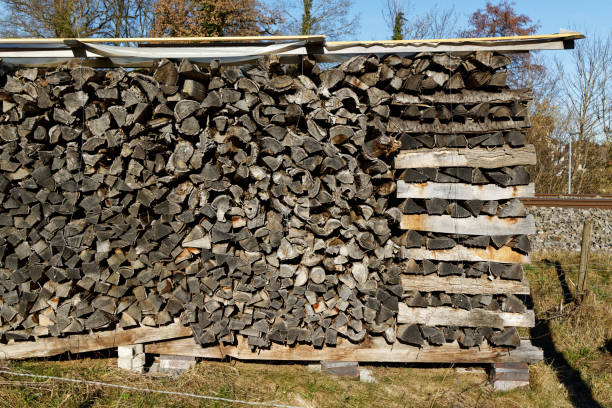 wood stack with cut gray brown wood, the energy security in the world is in danger, heating with wood is an important alternative