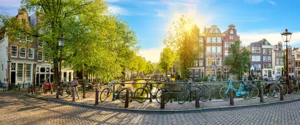 Photo of Panoramic view of a quiet morning Amsterdam. Houses, bridges, bicycles - old Amsterdam. Lovely morning in Amsterdam.