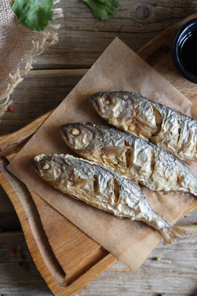 istock fried surmullet on board on old wooden table 1410281528