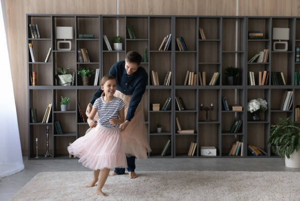 istock Happy young father and small daughter dancing at home. 1410282294