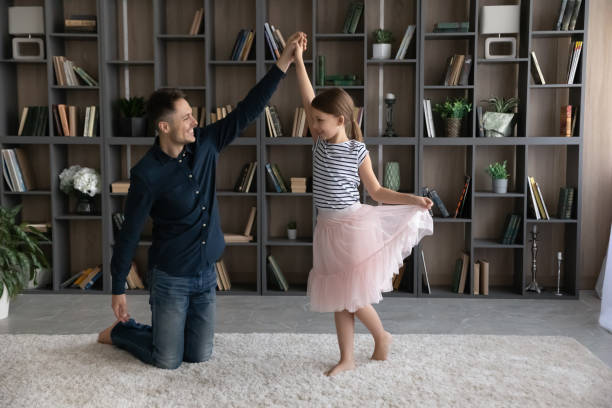 istock Happy young father dancing with little daughter. 1410282308