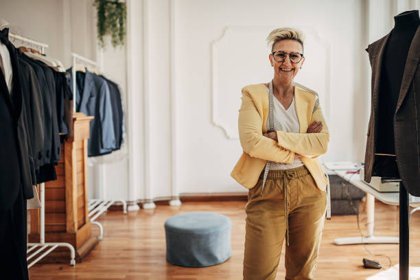 Female tailor Portrait of a female fashion designer in her design clothing studio. woman tailor stock pictures, royalty-free photos & images