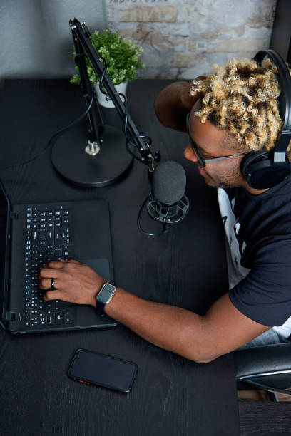 istock Black man communicates with podcast listeners in an online chat 1410285730