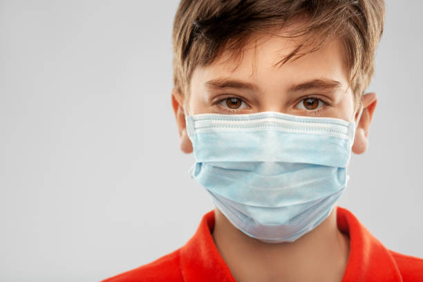 istock boy in protective medical mask 1410286464