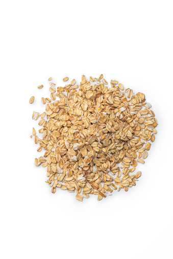 Healthy breakfast Organic oat flakes in a wooden bowl Grey textile background Top view Copy space