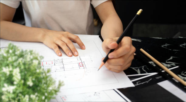 istock close up woman hand drawing on architectural blueprint paper 1410287941