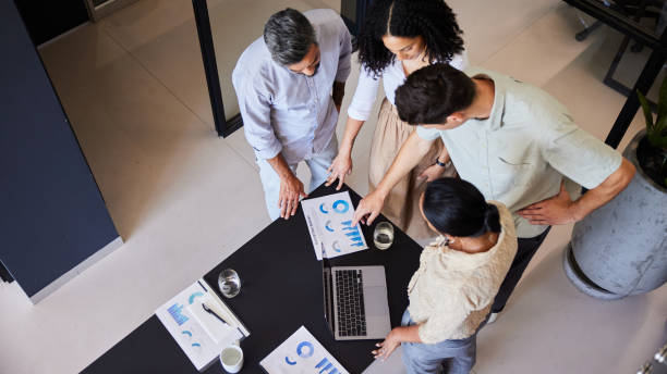 istock Businesspeople going over graphs and charts during an office meeting 1410290500