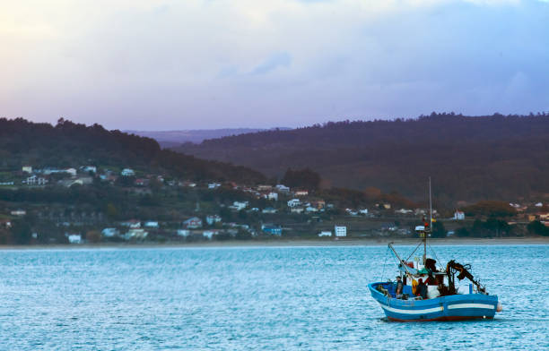 Fishing boat leaving Sada harbor . A Coruña province, Galicia, Spain. stock photo