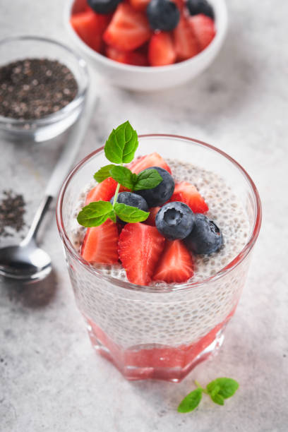 istock Chia strawberry pudding. Healthy vegan breakfast chia seeds pudding with fresh berries and mint in glass on gray concrete background. Concept of healthy eating, dieting, fitness menu. Selective focus. 1410293010