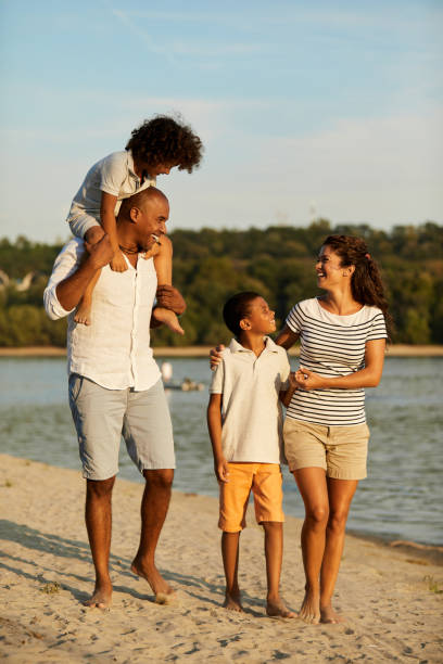 istock Beautiful family walking on the beach 1410293945