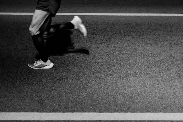 legs runner athlete run on asphalt at night