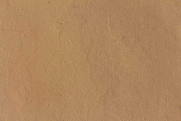 istock A painted plaster wall texture. A beige concrete wall background. 1410294225