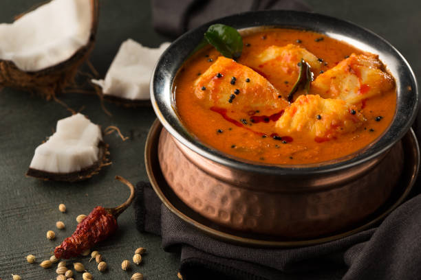 istock kumarakom fish curry served in golden dish isolated on dark background side view 1410295699
