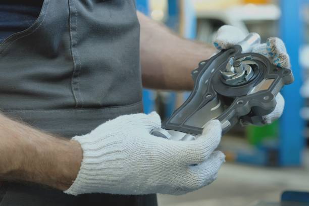 istock An auto mechanic holds a water pump for an automobile engine in his hands. Close-up. 1410296508