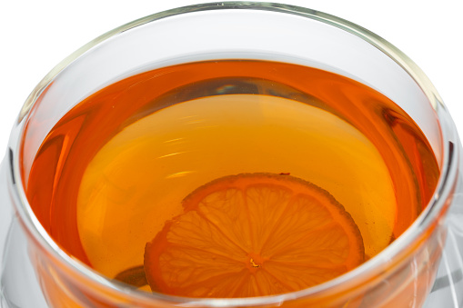 Glass cup of black tea isolated on white background