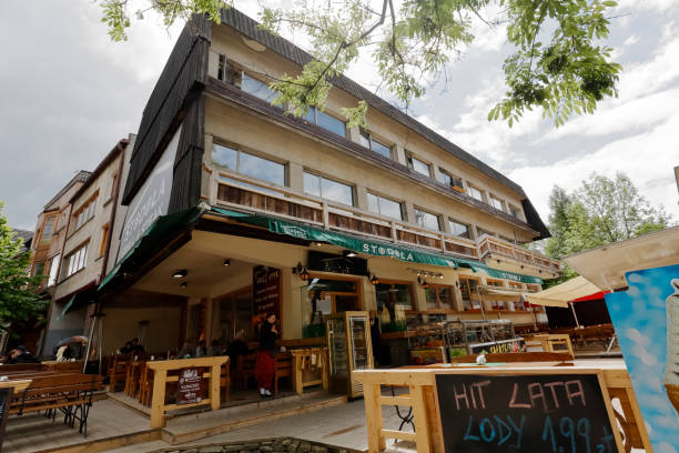 Orbis building in Zakopane Zakopane, Poland - June 21, 2015: Orbis building, built in 1970 and designed by J. Dajewski, the brick construction partly covered with wooden elements refers to the architectural style of the region orbis stock pictures, royalty-free photos & images