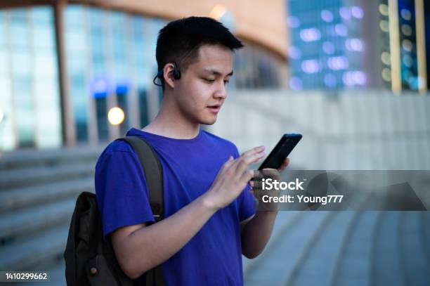 Asian Adult Student Using Smartphone At University Campus Stock Photo - Download Image Now