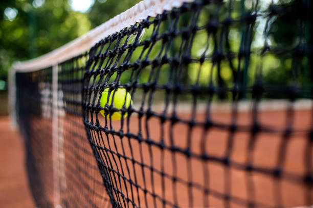 istock Tennis ball hitting a net 1410300909