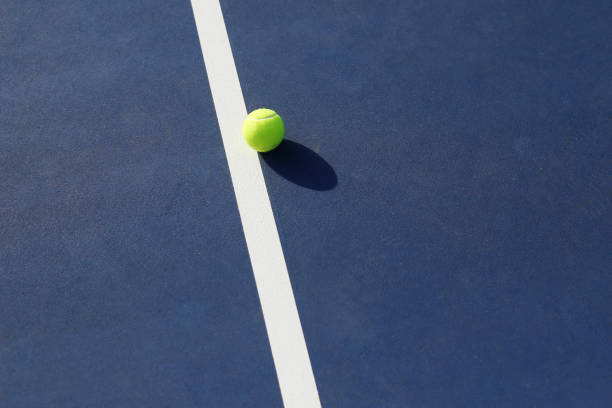 Tennis ball on a hardcourt stock photo