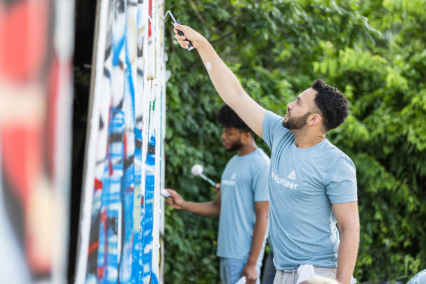 istock Colleagues work on cleaning up the community center wall 1410303174