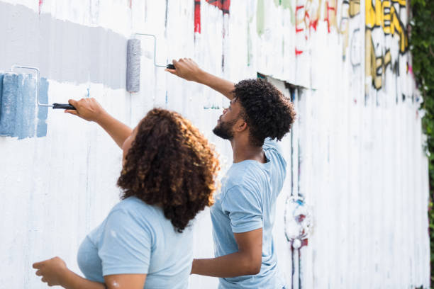 istock Volunteers work together to paint the wall 1410303210