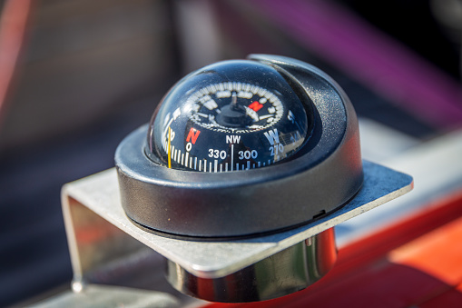 Close up of nautical compass on yacht.