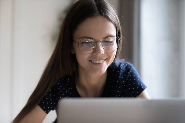 istock Smart student girl in glasses studying at home, using computer 1410305685