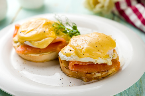 eggs Benedict with salmon on a white plate selective focus
