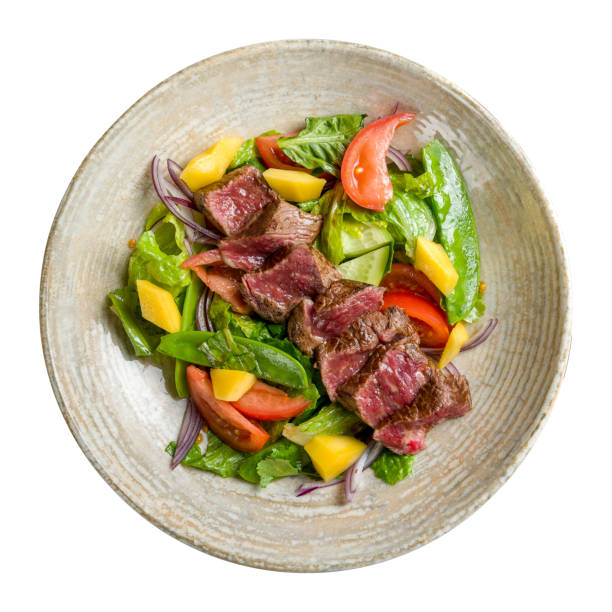 Image of veal with fresh vegetables on the plate indoors.