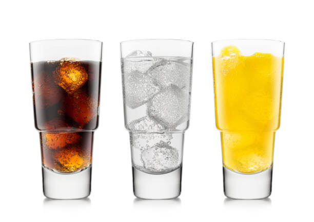 istock Three glasses with cola soft drink with orange soda and lemonade with ice cubes on white. 1410307775