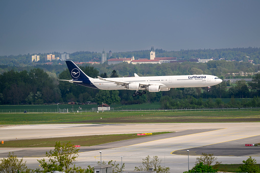 Munich, Germany - 09. May 2022 : Lufthansa Airbus A340-642 with the aircraft registration D-AIHI on approach to the northern runway 08L of the Munich Airport MUC EDDM