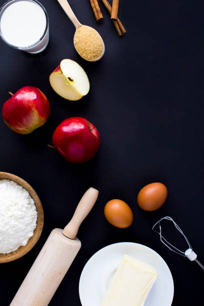 istock Top view of ingredients for making apple pie or cake on the black background. Copy space. 1410309227
