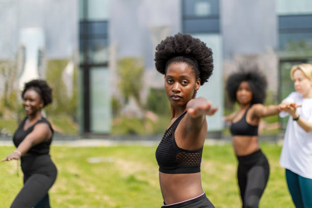 istock Young African Women Practicing Yoga In Public Park 1410309241