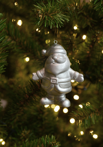 Closeup of a mass produced Santa Claus ornament on a Christmas Tree.