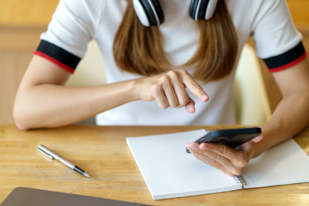 istock Closeup image of female using smartphone to send text , work or play social media. 1410315089