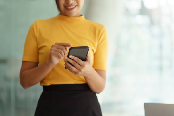 istock Closeup image of female using smartphone to send text , work or play social media. 1410315100