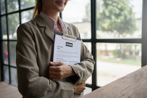 Close-up of business owner check resume of job applicants in company at the office.