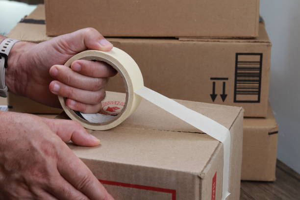 istock A person seals a cardboard package 1410316960
