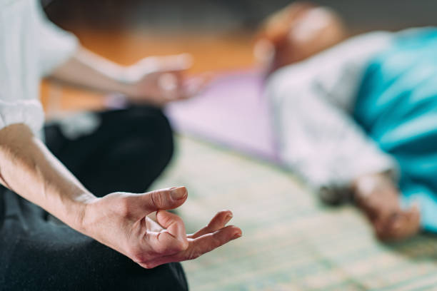 istock Senior woman on a guided meditation class 1410318302