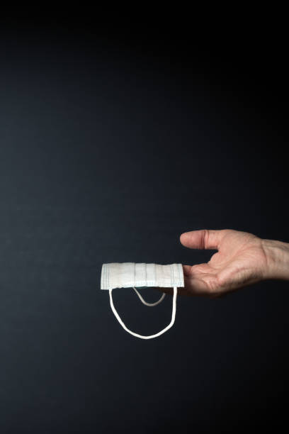 istock male hand holding covid medical mask 1410318521