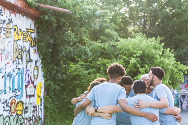 istock Volunteers for park clean-up begin day in huddle 1410319923
