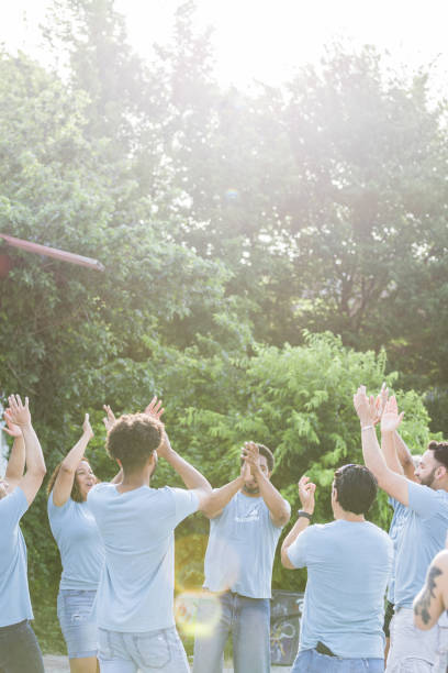 istock Diverse volunteers standing in circle clap and cheer 1410319926