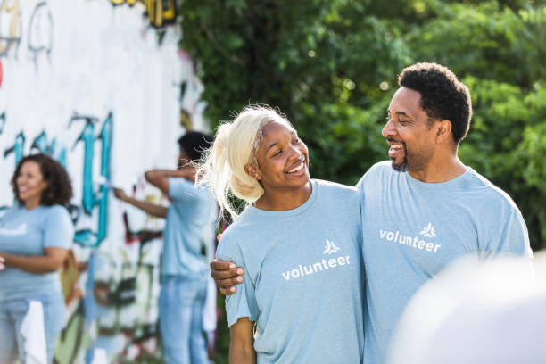 istock Dad and daughter smile at each other during volunteer day 1410319935