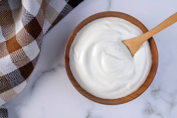 istock Greek yogurt in wooden bowl 1410321594
