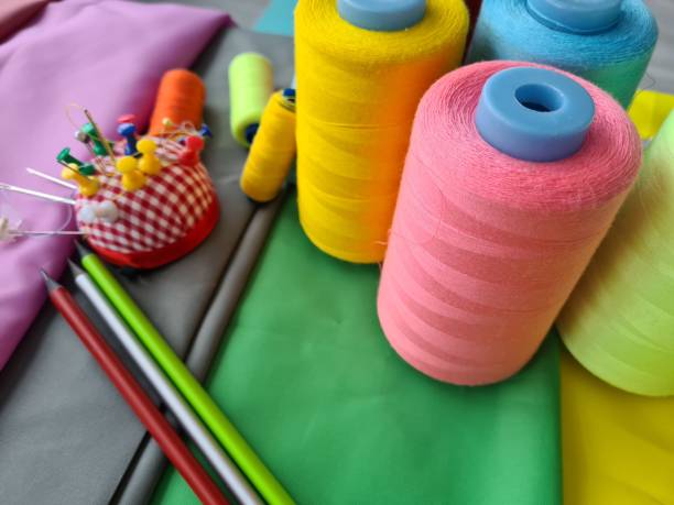 istock Concept of tailor fashion design craftsmanship. Fabric and sewing tools on table 1410321666