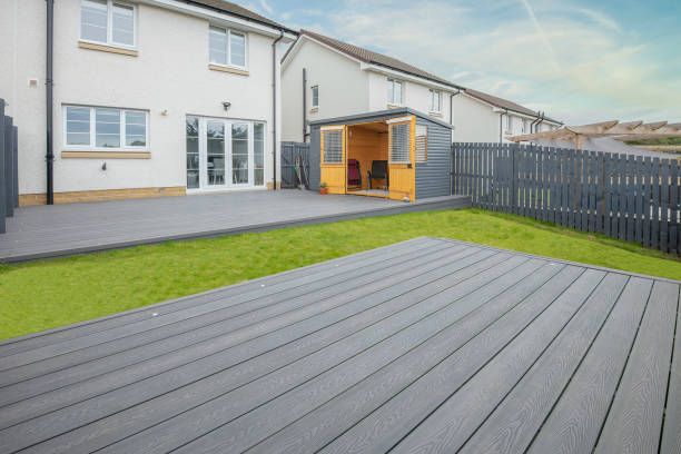 istock Newlly constructed decking over two levels with deck lighting installed and in Ash grey colour with summer house painted in the same matching colour.Good Image for a landscape Gardiner 1410321918