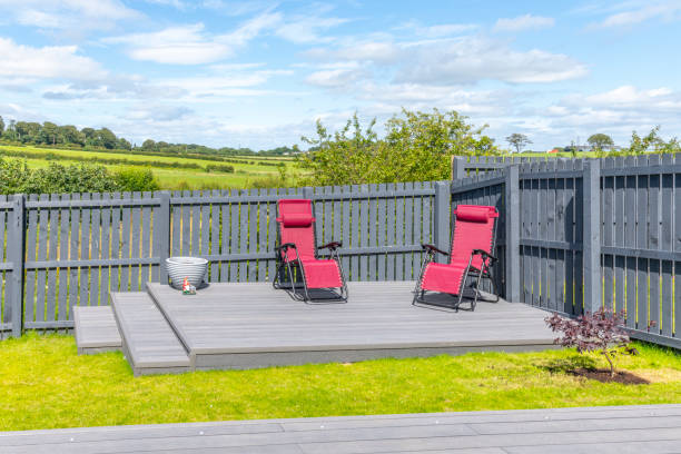Ash grey composite decking built on two levels on a residential back garden with low voltage deck lights installed as well. Good Image for a landscape Gardiner