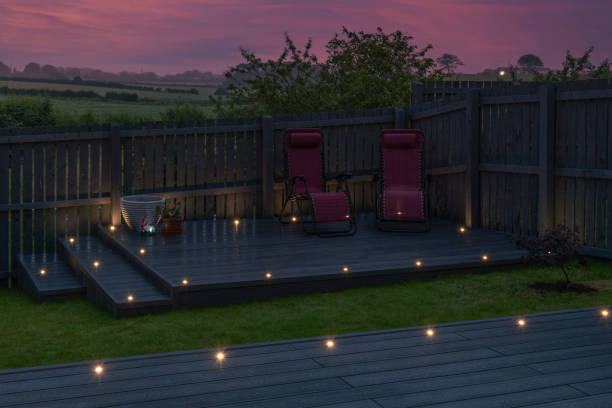 istock Newlly constructed decking over two levels with deck lighting installed and in Ash grey colour with summer house painted in the same matching colour.Good Image for a landscape Gardiner 1410321952