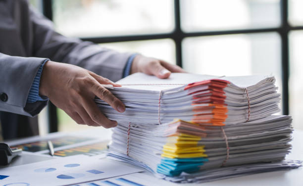 istock business documents businessman check legal document review Prepare documents or analysis reports, tax items, accounting documents, data contracts, office partner agreements. 1410322727