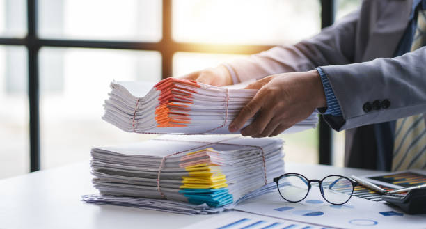 istock business documents businessman check legal document review Prepare documents or analysis reports, tax items, accounting documents, data contracts, office partner agreements. 1410322728